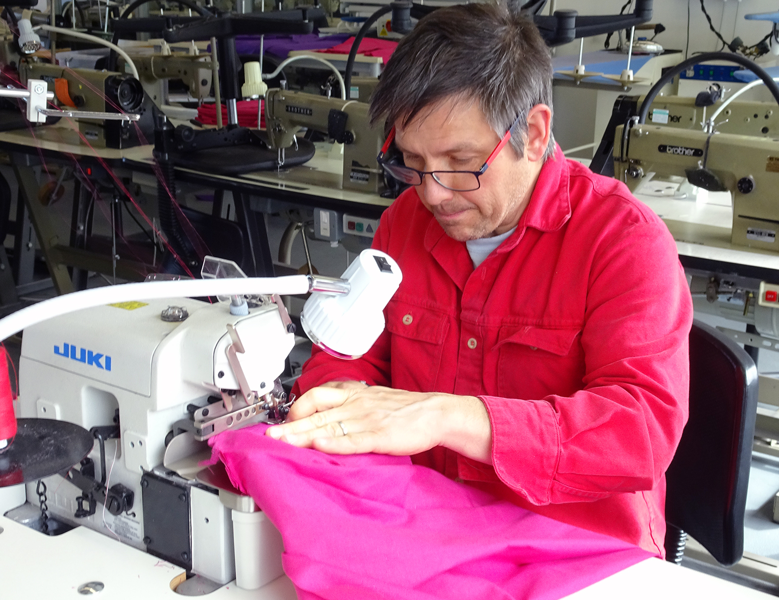 Man using overlocker sewing machine