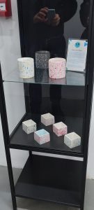 Small geometric jesmonite and plastic objects in display case